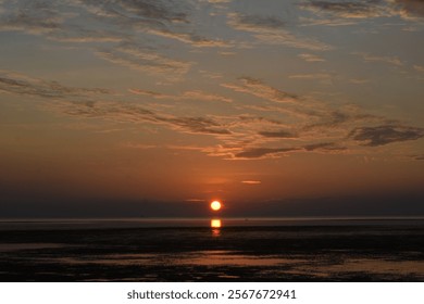 Dramatic sunset sky with clouds. Dramatic sunset over the sea