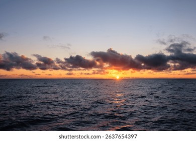 Dramatic sunset sky with clouds. Dramatic sunset over the sea