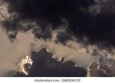  Dramatic sunset sky with dark clouds and sunbeams.