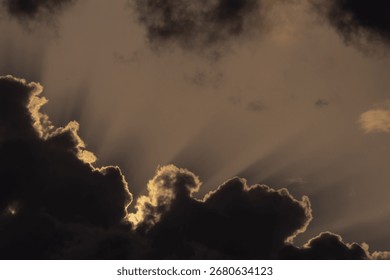  Dramatic sunset sky with dark clouds and sunbeams.
