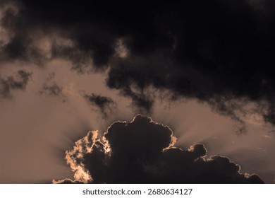  Dramatic sunset sky with dark clouds and sunbeams.