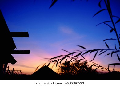 Dramatic sunset sky with deep blue and pink hues, captured from a rooftop. A detailed shot showcasing the vibrant evening colors and atmospheric twilight