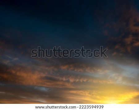 Dramatic sunset sky for design purpose of sky replacement. Nature background. Rich dark blue and warm orange color tone.