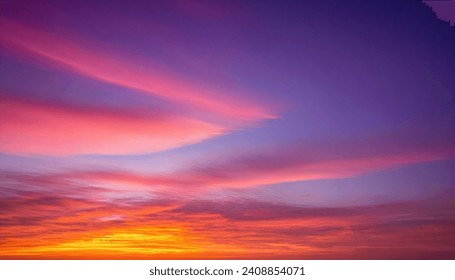 Dramatic Sunset sky in the evening with a lot of clouds and sun flares cinematic view of blue and orange dark clouds
