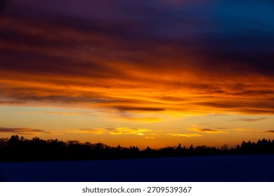 Dramatic sunset sky and forest silhouette