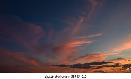 Dramatic sunset sky with orange colored clouds.