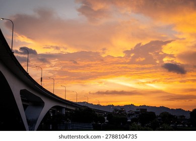 Dramatic sunset sky over an elevated bridge in the city