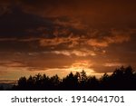 Dramatic sunset in sky over landscape. Stock Photo