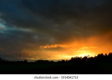 Dramatic sunset in sky over landscape. Stock Photo