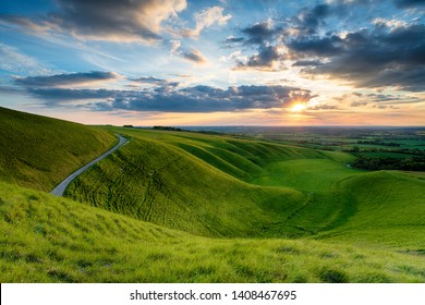 Dramatic sunset sky over The Manger at Uffington in Oxforshire, it is on the Ridgeway long distance walking route and forms part of the Berkshire Downs and on the border of Wiltshire