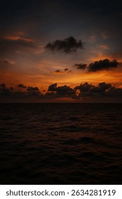 Dramatic sunset sky over the ocean with vivid orange and purple tones, capturing a peaceful and contemplative moment in nature.