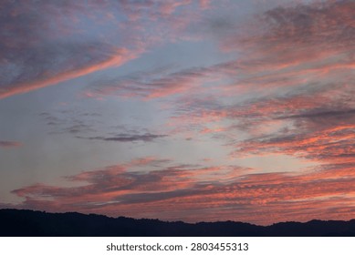 Dramatic Sunset Sky Over Silhouetted Hills