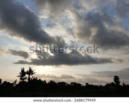Dramatic Sunset Sky with Silhouetted Trees and Clouds