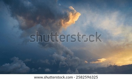 Dramatic sunset sky with yellow, blue and orange thunderstorm clouds. High resolution photography for sky replacement, background or graphic design