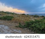 Dramatic sunset with storm cloudscape over Mediterranean Sea and coastline. Cape Greko, Cyprus.
