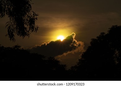 Dramatic sunset sun in clouds.