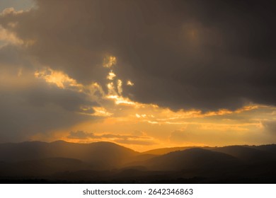 Dramatic sunset with sun rays breaking through clouds.