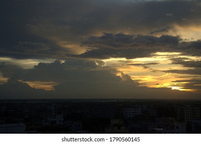 Dramatic sunset with sun rays through the clouds. Beautiful sky with volumetric clouds during sunset in summer. 