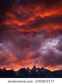 Dramatic sunset in the Tetons with glowing red clouds
