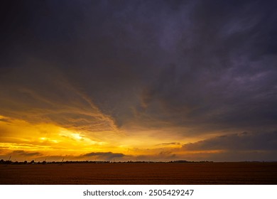 Dramatic sunset thunderstorm sky over an open field - Powered by Shutterstock