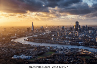 Dramatic sunset view of the iconic skyline of London, England, during a stormy day with river Thames and the modern Skyscrapers of the City - Powered by Shutterstock