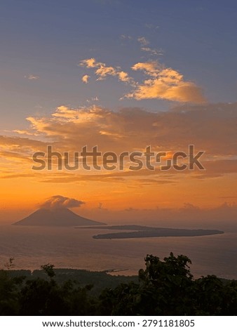 Dramatic Sunset View Over the Sea, Manado Tua Volcano and Bunaken Island, North Sulawesi, Indonesia.