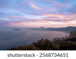 Dramatic sunset 🌅 views from Monte Pellegrino’s Belvedere in Palermo, capturing the rugged Mediterranean coastline against a canvas of golden-orange clouds.