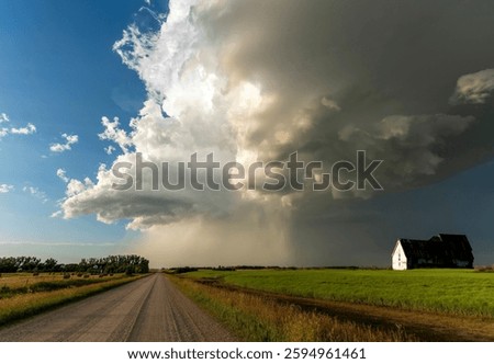 Dramatic supercell storm clouds forming over a farm in the canadian prairies