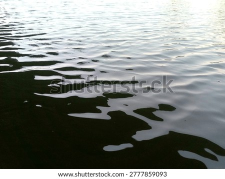 The dramatic surface of the lake with small ripples due to the wind
