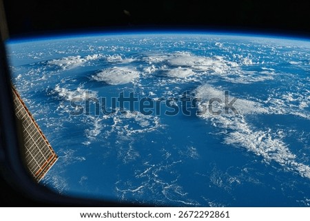 Dramatic swirling cloud formation over the ocean from an elevated perspective. Earth from space, a stunning view of our planet. Earth atmosphere. Elements of this image furnished by NASA