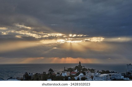 Dramatic thunderclouds over mediterranean sea with sun rays breaking through