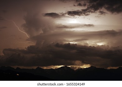 dramatic thunderstorm, lightning behind clouds