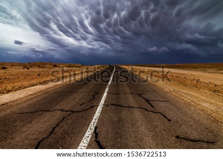 Dramatic thunderstorm sky over an old empty road.
