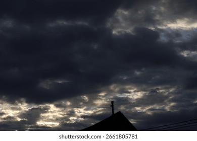 Dramatic timelapse of dark storm clouds rolling across a turbulent blue sky at sunset