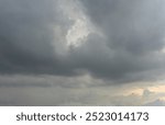 Dramatic timelapse of storm clouds gathering in the blue sky, casting dark shadows on the landscape below