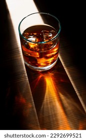 Dramatic top vertical view of a glass of whiskey with ice cubes