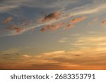 Dramatic twilight sky with glowing orange clouds above horizon. Great for sky backgrounds, evening, and landscape scenes.