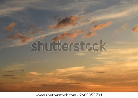 Dramatic twilight sky with glowing orange clouds above horizon. Great for sky backgrounds, evening, and landscape scenes.