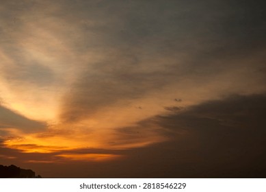 Dramatic twilight sky over the ocean horizon during sunset at a rocky beach coast in Bali.
Stunning dramatic red and orange sunset sky over the ocean horizon in Bali, Indonesia.
Beautiful tropical golden hour sunset view from a coastal cliff overlooking the sea waves.
