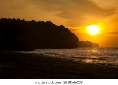 Dramatic twilight sky over the ocean horizon during sunset at a rocky beach coast in Bali.
Stunning dramatic red and orange sunset sky over the ocean horizon in Bali, Indonesia.
Beautiful tropical golden hour sunset view from a coastal cliff overlooking the sea waves.