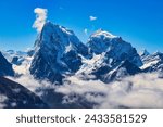 Dramatic twin peaks of Cholatse and Taboche against a bright blue sky seen from Gokyo Ri, Nepal