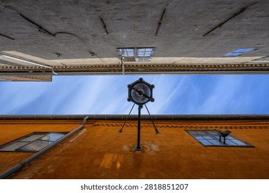 Dramatic upward view between old buildings and sky