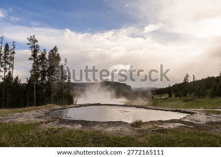 A dramatic view of the Churning Caldron, a highly active and bubbling geothermal pool in the Mud Volcano area of Yellowstone National Park.