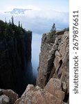 A dramatic view from the cliffs of Sleeping Giant Provincial Park in Ontario, Canada, with Lake Superior and clouds in the distance.