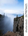 A dramatic view from the cliffs of Sleeping Giant Provincial Park in Ontario, Canada, with Lake Superior and clouds in the distance.