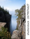 A dramatic view from the cliffs of Sleeping Giant Provincial Park in Ontario, Canada, with Lake Superior and clouds in the distance.