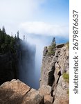 A dramatic view from the cliffs of Sleeping Giant Provincial Park in Ontario, Canada, with Lake Superior and clouds in the distance.