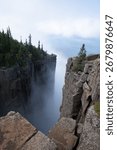A dramatic view from the cliffs of Sleeping Giant Provincial Park in Ontario, Canada, with Lake Superior and clouds in the distance.