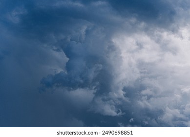 Dramatic view of dark storm clouds forming in the sky, indicating an impending storm with contrasting shades of blue and gray. 