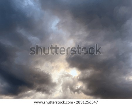Dramatic view of dark storm clouds overcasting bright blue sky background before heavy rain, beautiful natural pattern of heavy grey cumulus thunderclouds and stormclouds before intense thunderstorm at summer day, climate and meteorology concept.
